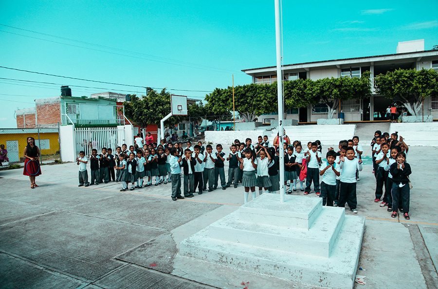 Elementary school students standing in front of their school in Atencingo, Mexico.